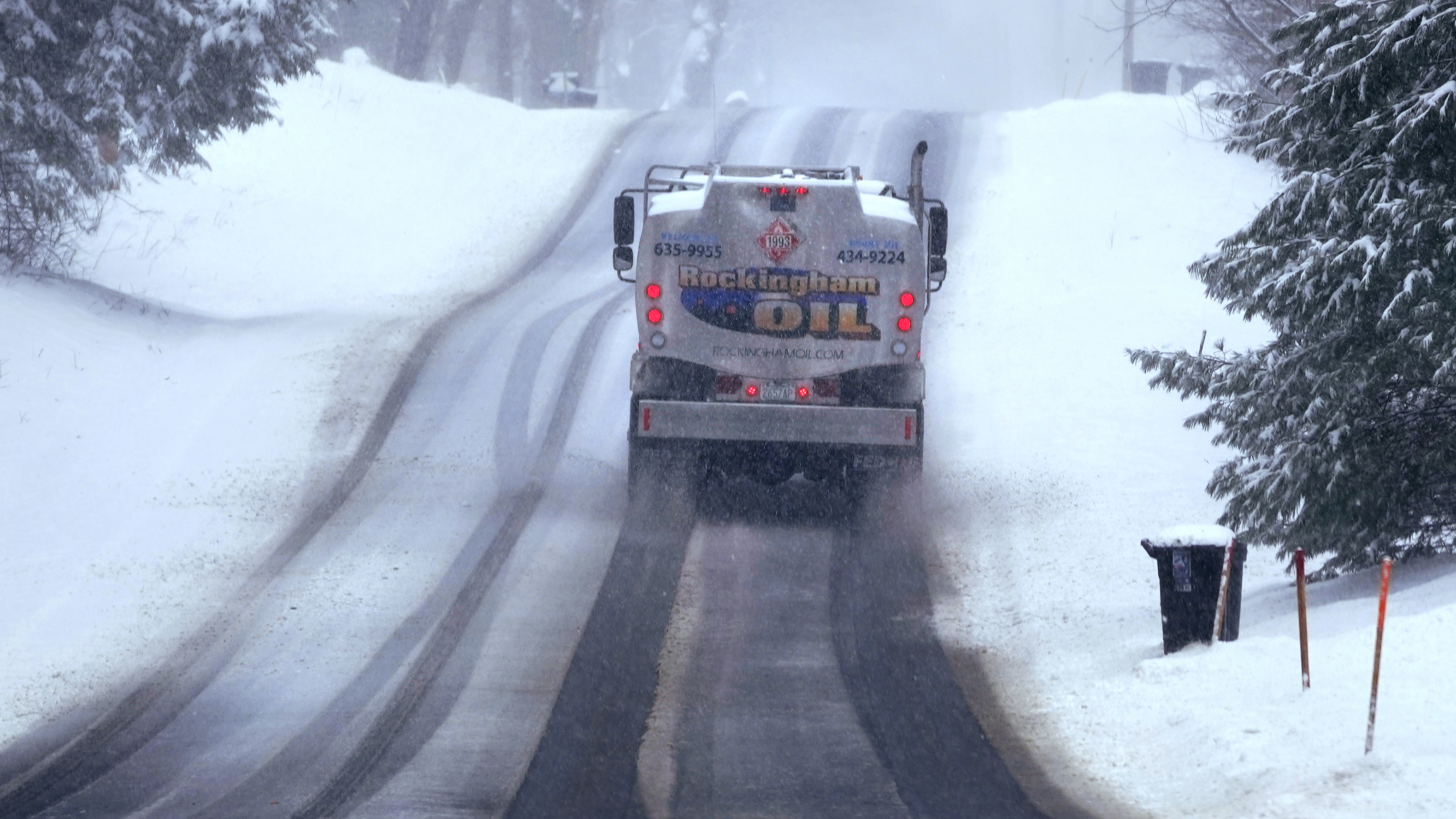 FILE - A home heating oil delivery truck climbs a snow covered road, Feb. 28, 2023, in Derry, N.H. Americans who struggled because of inflation may get a break on heating costs this winter. The federal government says nearly half the nation that uses natural gas for heat is projected to see lower costs while electricity remains relatively stable, but there’s angst in the nation’s northeast corner with projections for higher heating oil costs. The Biden administration released most of the current $4 billion in home energy assistance to states on Tuesday, Oct. 24. (AP Photo/Charles Krupa, File)